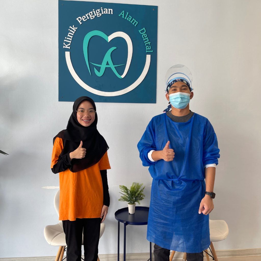 Happy braces patient at Alam Dental Hutan Melintang Teluk Intan with her dentist after dental treatment