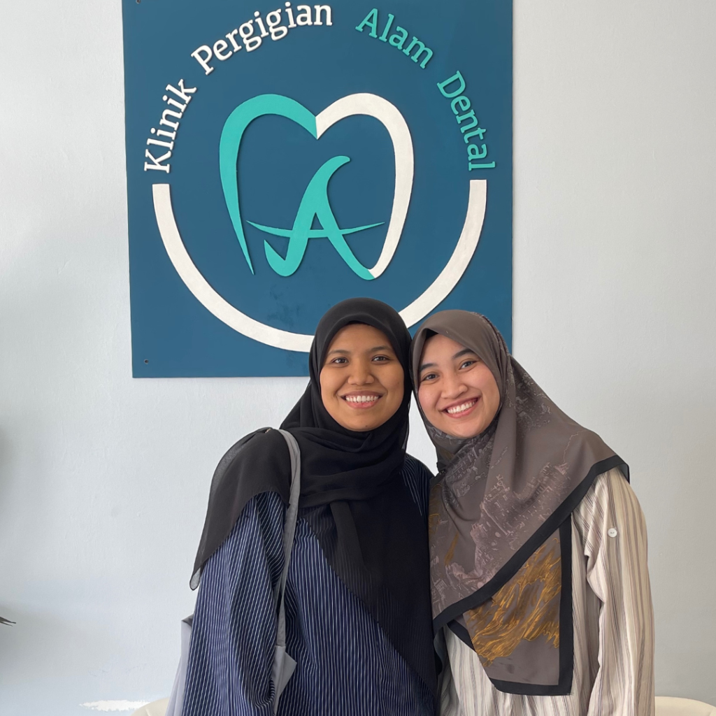 Happy braces patient at Alam Dental Hutan Melintang Teluk Intan with her dentist after dental treatment