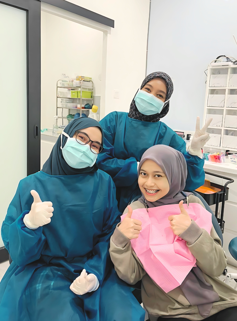 happy braces patient at dental clinic experiencing pain free treatment for new smile makeover. dental clinic hutan melintang